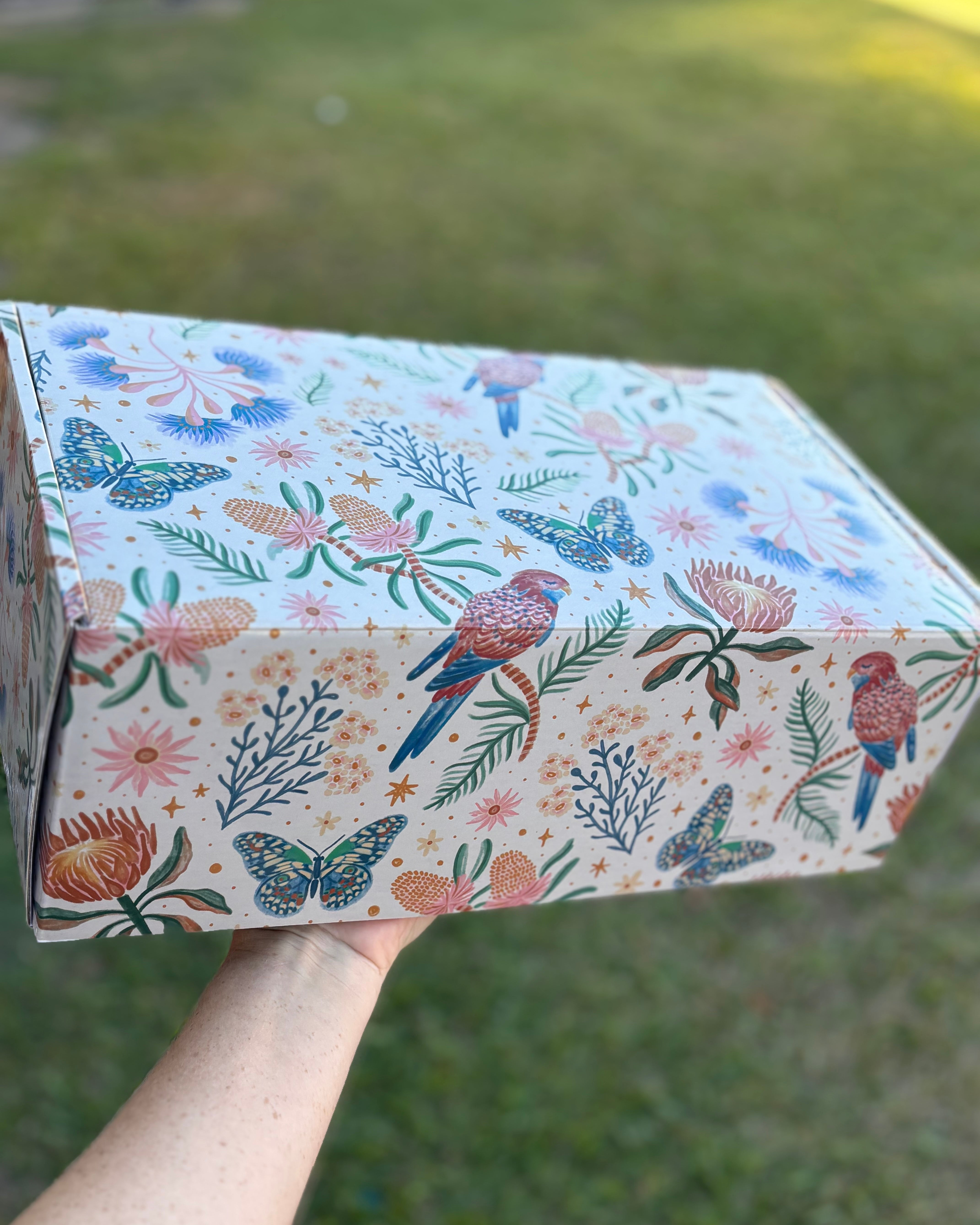 a gift box with birds and flowers on it
