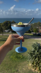 Insulated cocktail cup with straw at the beach