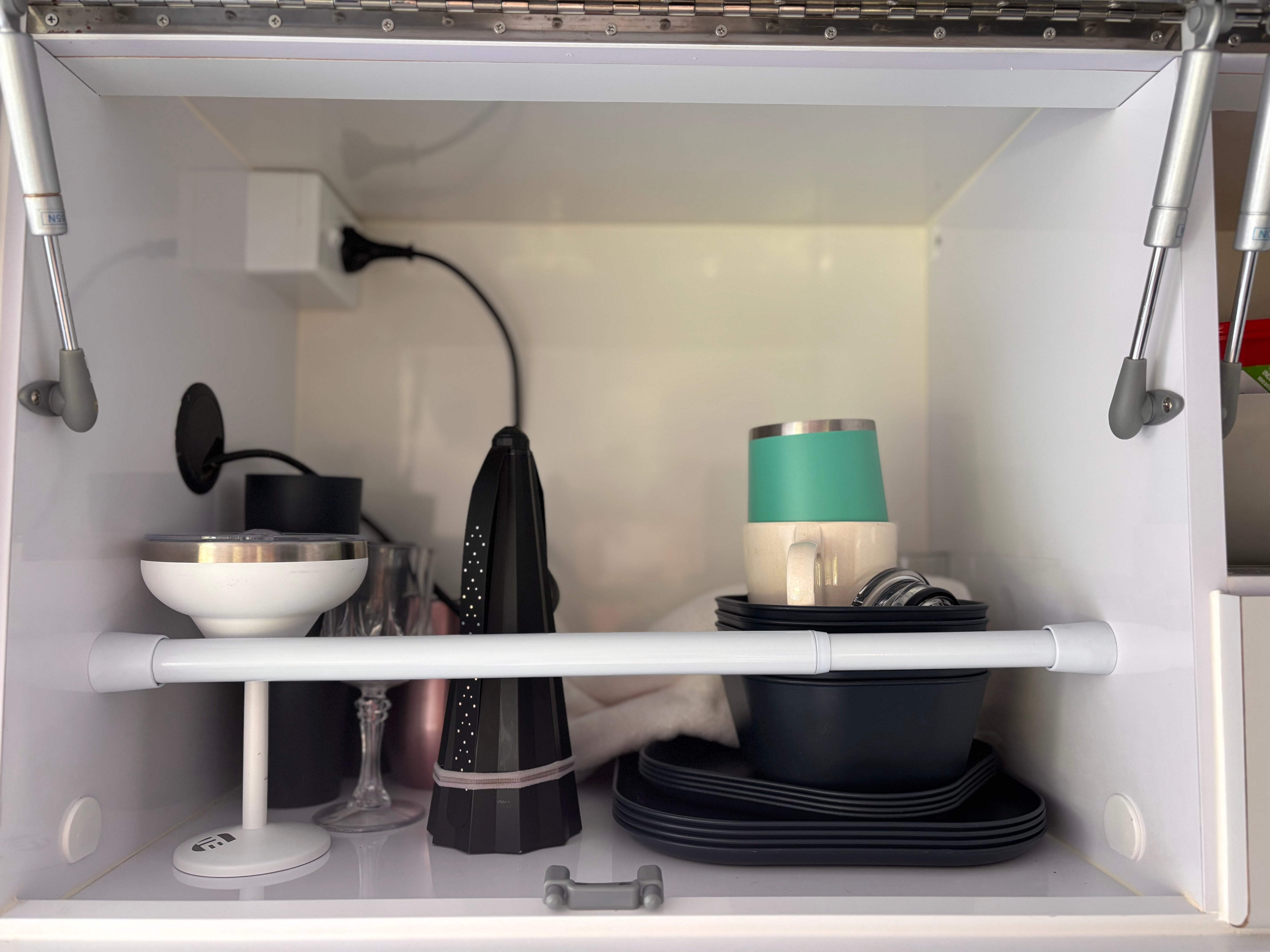 a cupboard with cups, plates and a protector