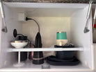 a cupboard with cups, plates and a protector