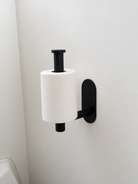 black toilet roll holder in use
