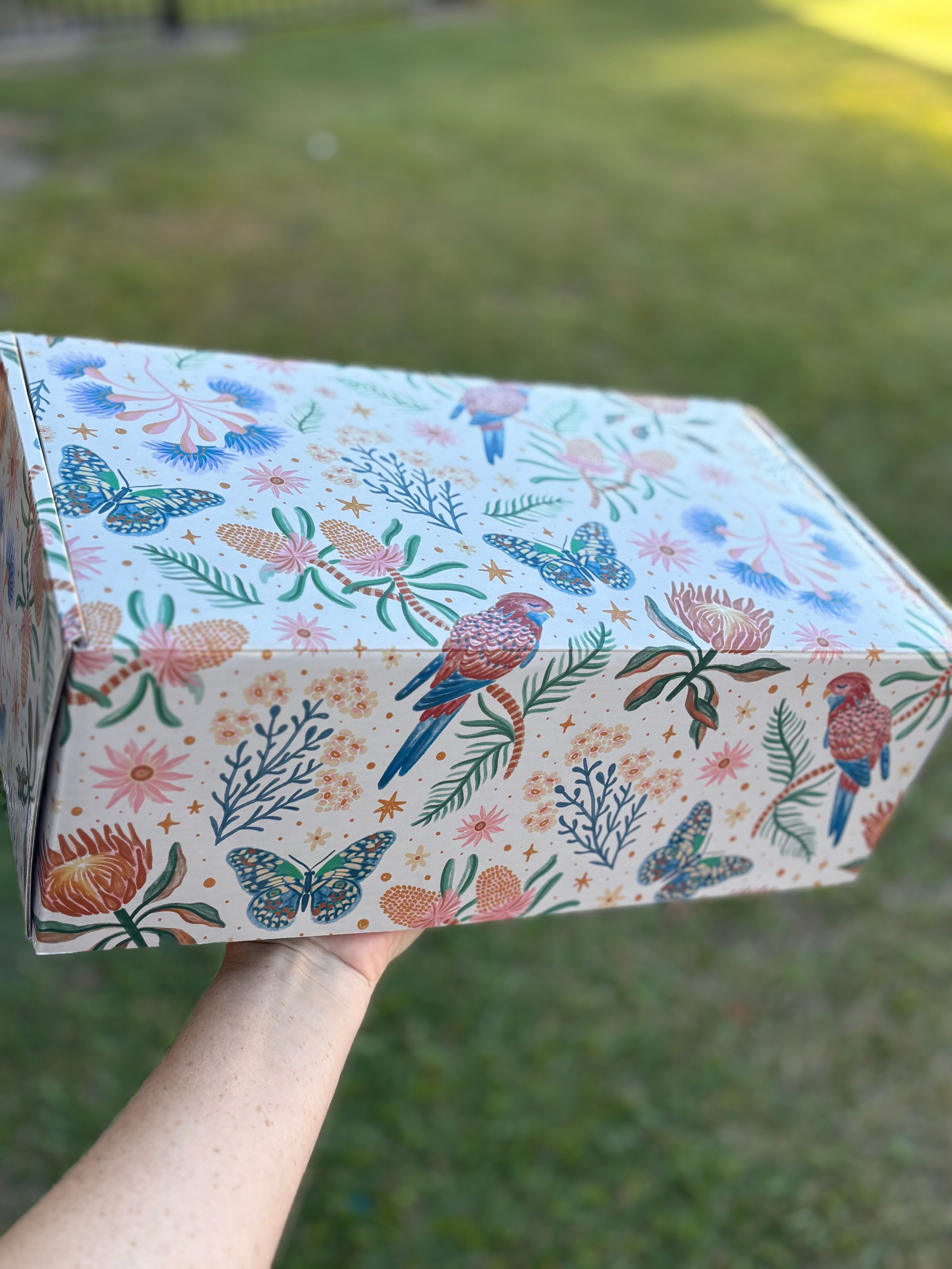 a gift box with birds and flowers on it 
